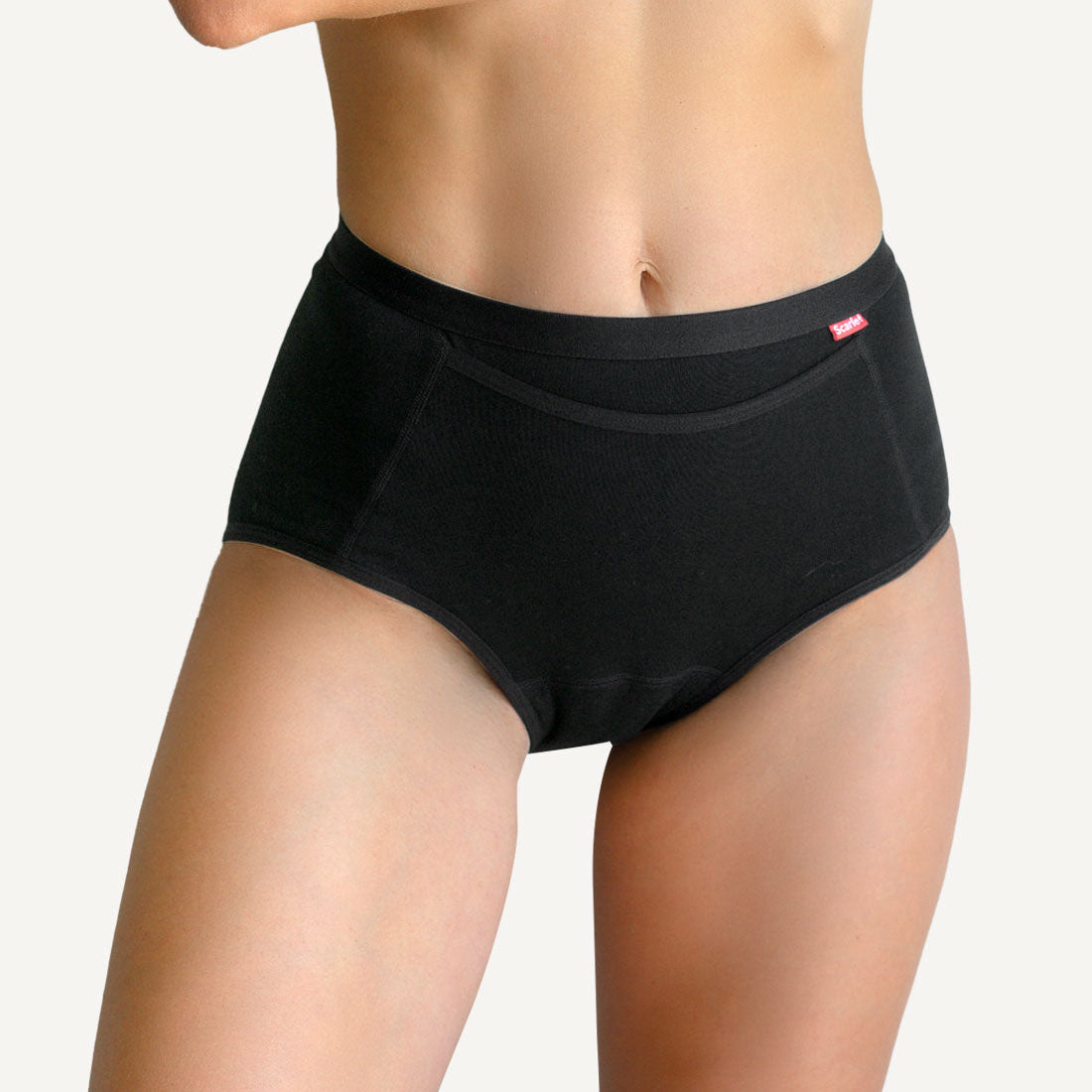 Scarlet Everyday Pocket Brief in black, worn high on the waist, with the front pocket that holds rae