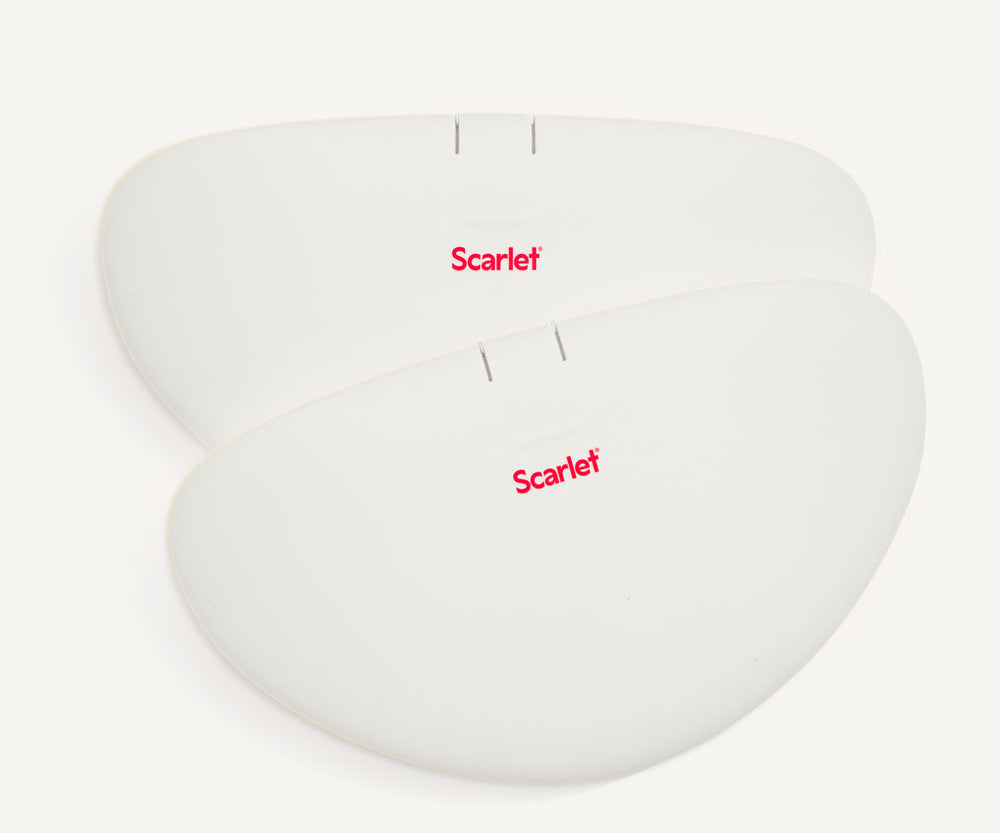 Two white rae heat pads stacked on a pale background